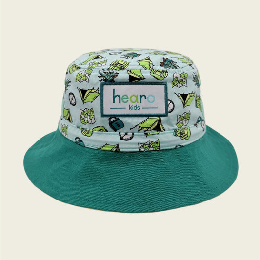 Bucket hat with a patterned brim and solid green bill on a beige background