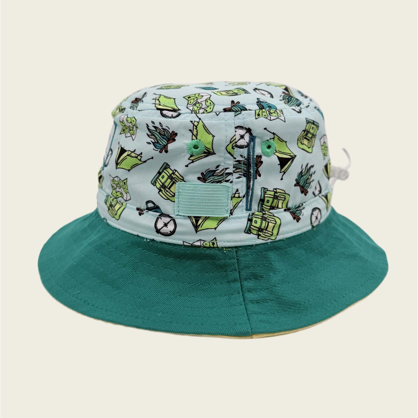 Bucket hat with camping design on light blue fabric and solid green brim