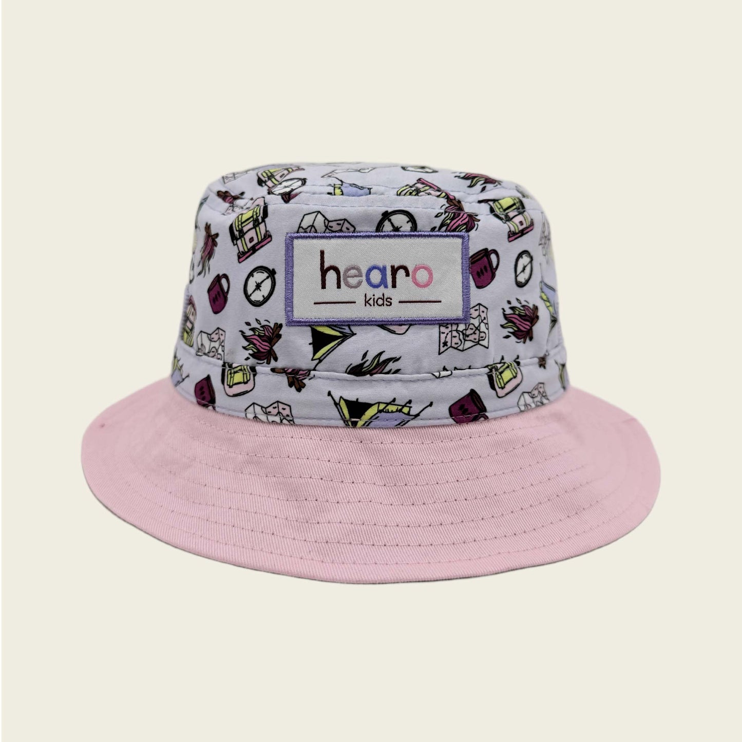 Bucket hat with colorful pattern and pink brim on a beige background