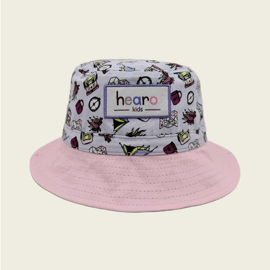 Bucket hat with colorful pattern and pink brim on a beige background