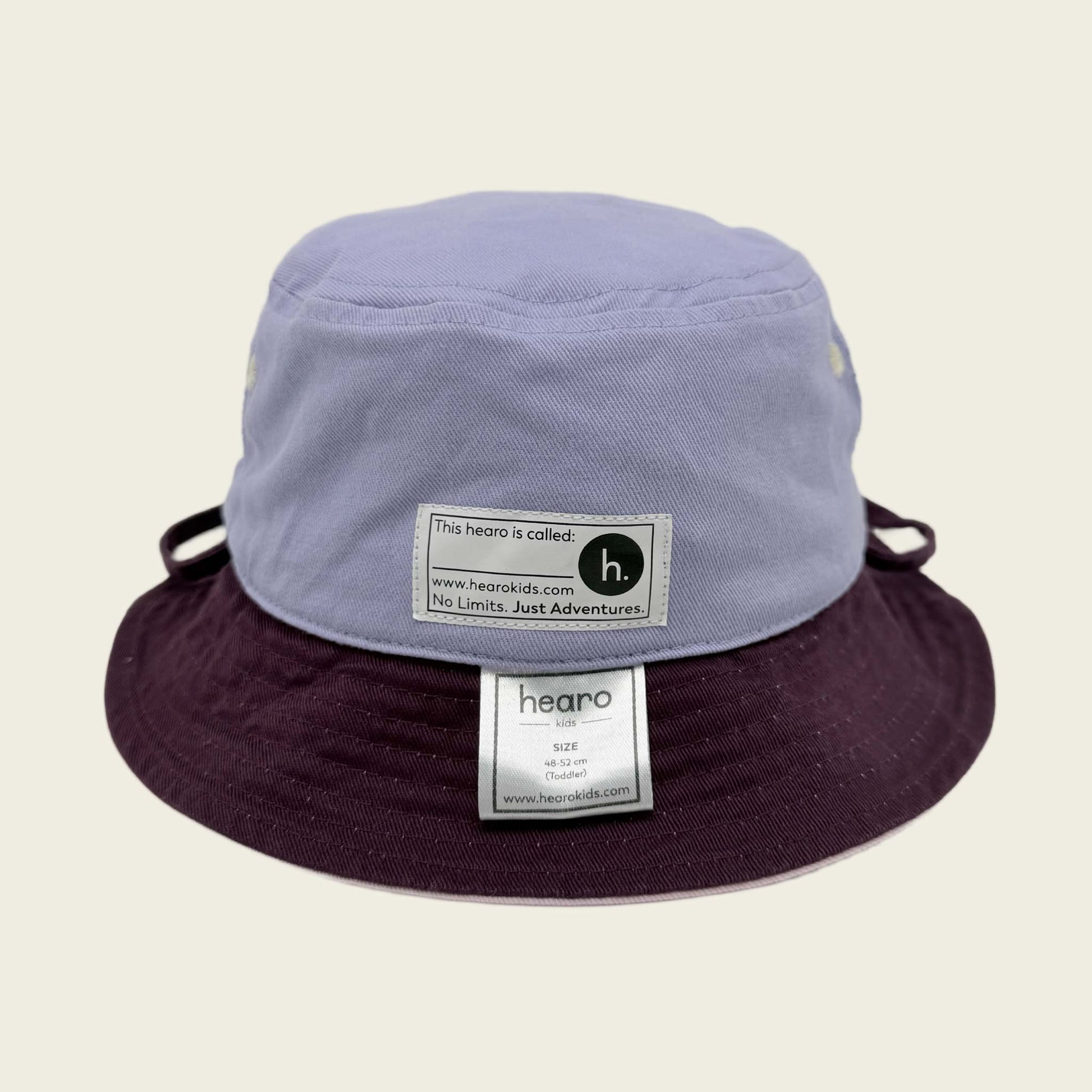 Two-tone bucket hat with visible name label on a beige background