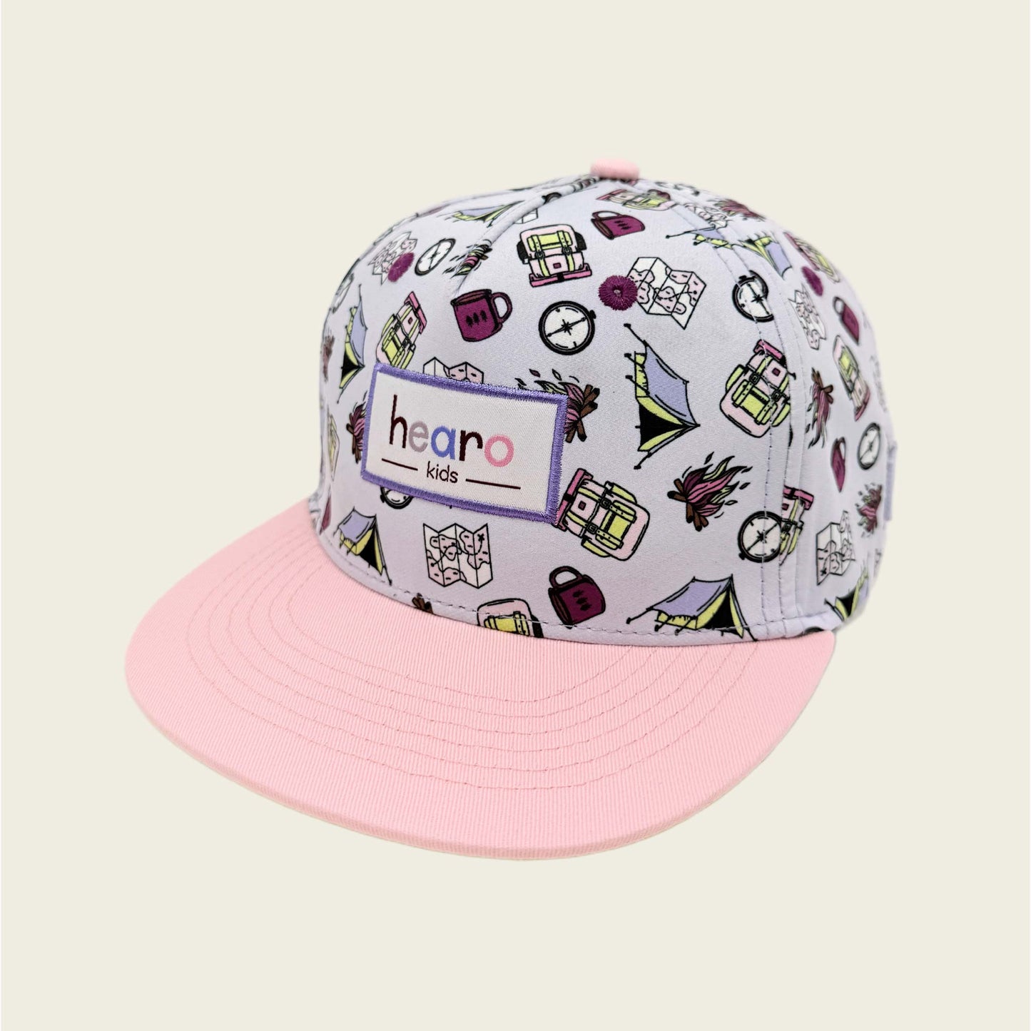 Cap with colorful pattern and pink brim on a beige background